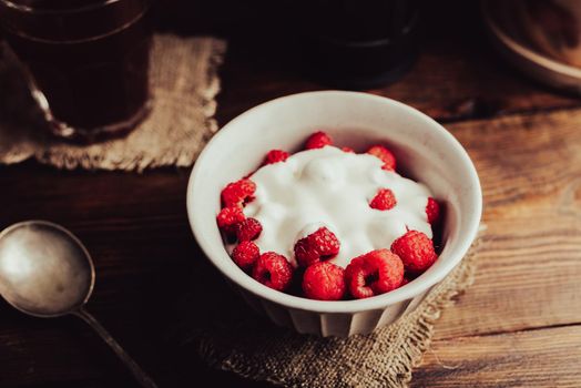 Summer Dessert with Fresh Raspberry and Cream in Bowl and Glass of Coffee