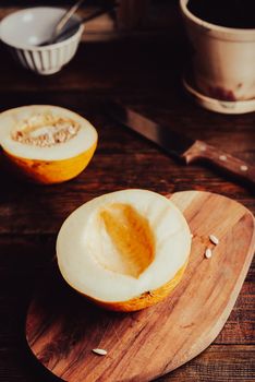 Half of Ripe Honeydew Melon without Seeds on Cutting Board