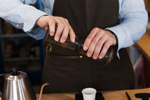 Aeropress coffee alternative making by barista in the cafe. Barista connect details from aeropress together. prepare aeropress to pour it