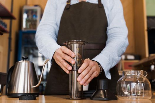 Aeropress coffee alternative making by barista in the cafe. Barista connect details from aeropress together. prepare aeropress to pour it