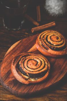 Sweet roll with poppy seeds. Glass of black coffee