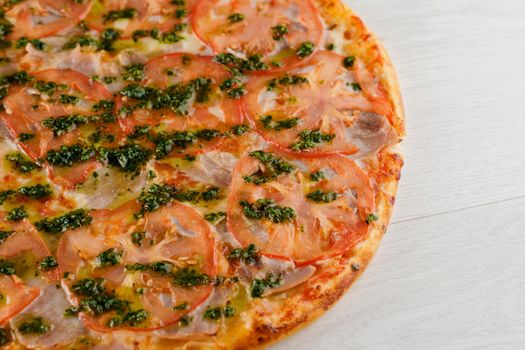 Pizza with tomatoes, cheese, meat, basil sauce isolated on white wooden background. Advert for social network of restaurants, caffee. Promotion for pizzeria