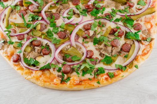 pizza with sausages, cucumber, pepper, cheese, onion isolated on white wooden background. Advert for social network of restaurants, caffee. Promotion for pizzeria