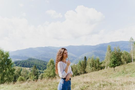 Girl enjoying the mountain hills view. Feeling freedom in Karpathian mountains. Tourism travelling in Ukraine.