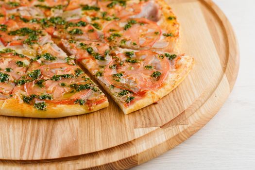 Pizza top view cutted on 8 pieces and one pushed forward. Advert for pizzeria caffee and restaurant. Food delivery at quarantine covid-19 concept.