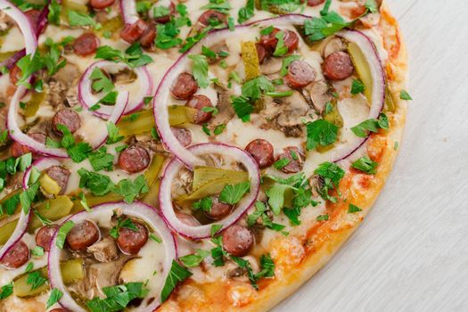 pizza with sausages, cucumber, pepper, cheese, onion isolated on white wooden background. Advert for social network of restaurants, caffee. Promotion for pizzeria