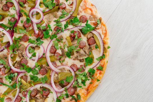 pizza with sausages, cucumber, pepper, cheese, onion isolated on white wooden background. Advert for social network of restaurants, caffee. Promotion for pizzeria