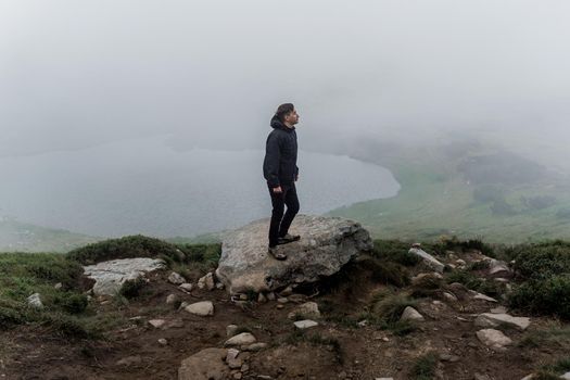 Men tourist is travelling and walking to the peak of mountain. Hiking and climbing up to the top of the mountain. Tourism in Ukraine.