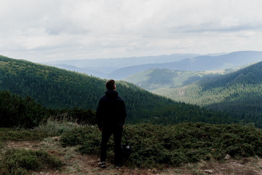 Hiking and climbing up to the top of the mountain. Men tourist is travelling and standing at the root of the mountain and watching to the peak.