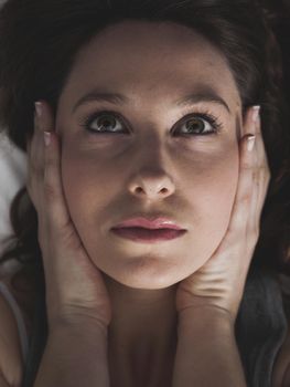 Porttrait of a young woman in pain with a headache