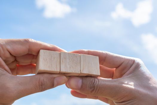 Blank wooden cube that you can put text or icon on in hand hold background