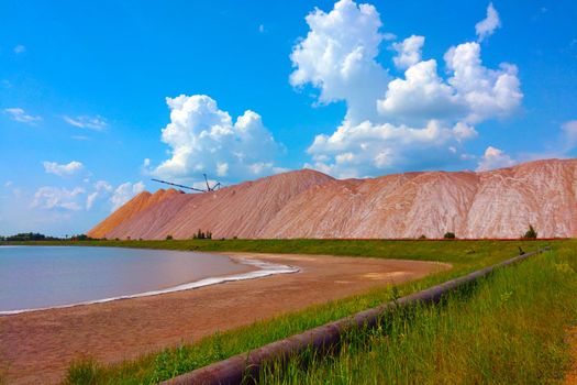 View of the large production mountains of waste ore. Extraction of salt and other minerals, out of focus