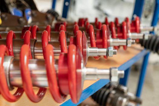 A row of red shock absorbers for car