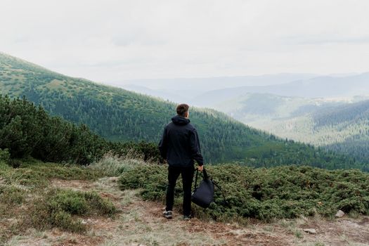 Hiking and climbing up to the top of the mountain. Men tourist is travelling and standing at the root of the mountain and watching to the peak.