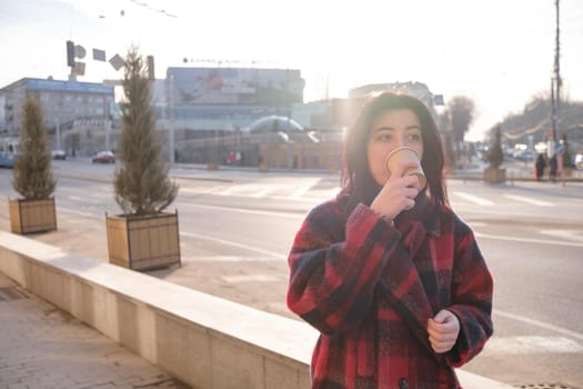 Woman drinking coffee in the sun, outdoor in sunlight light, enjoying her morning