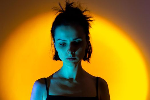 art portrait of a woman with blue light on her face, yellow background,. High quality photo