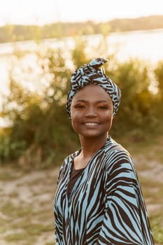 Happy muslim girl close up in trendy traditional clothes smiles. Woman in traditional blue hijab