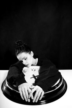 sad woman with big clock, black background. High quality photo