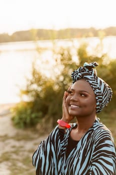 Happy muslim girl close up in trendy traditional clothes smiles. Woman in traditional blue hijab