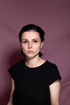 woman in black t-shirt on pink background. High quality photo
