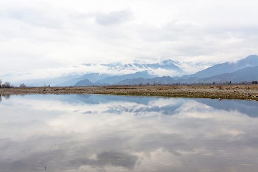 Beautiful landscape view of mountains covered with snow and clouds