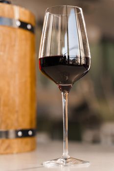 Special wine pours from wooden barrel. Red France wine into a wine glass.