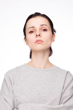 emotional woman in a gray sweatshirt, white background. High quality photo