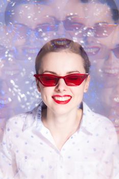 art portrait of a woman in glasses with red lipstick on her lips in a white shirt. High quality photo