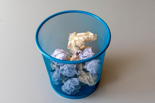 Mesh basket filled with crumpled paper balls