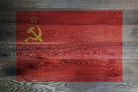 A USSR flag on rustic old wood surface red yellow hammer sickle CCCP