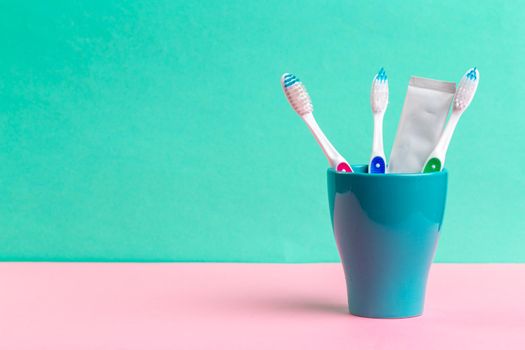 Toothbrushes in glass on the table