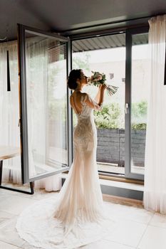 Bride in wedding dress and bridal veil in cafe. Advert for social networks for wedding agency and bridal salon