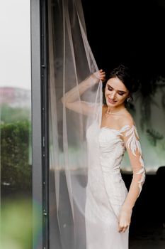 Bride in wedding dress and bridal veil in cafe. Advert for social networks for wedding agency and bridal salon