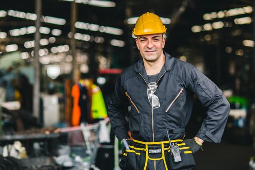 Happy worker, portrait smile handsome labor with safety suit tools belt and radio service man in factory.