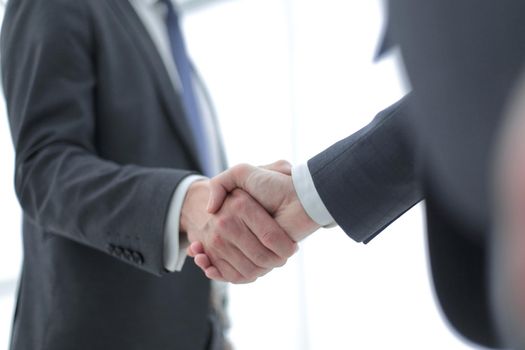 close up. handshake of business people on a light background.the concept of cooperation