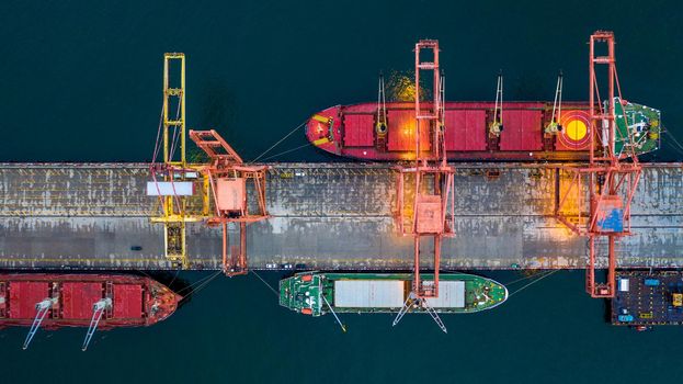 Aerial view bulk carrier dock, Global business import export logistic and transportation company, Commercial dock container cargo vessel freight shipping worldwide.