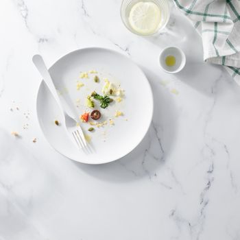 Empty dirty white plate with Vegetable Salad top view