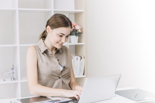 Business woman office girl enjoy working on desk with laptop smiling