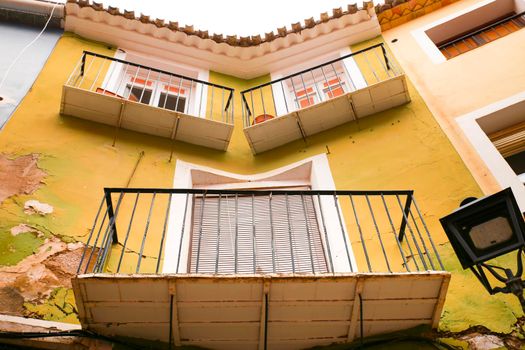 Old colorful asymmetric facade in Villajoyosa, Alicante, Spain