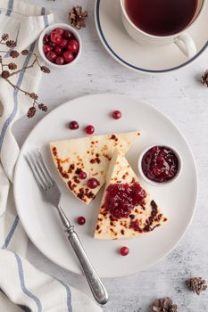 Leipajuusto - traditional Finnish baked cheese - with red berries in a plate