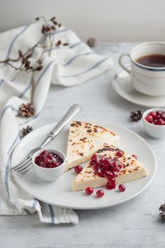 Leipajuusto - traditional Finnish baked cheese - with red berries in a plate