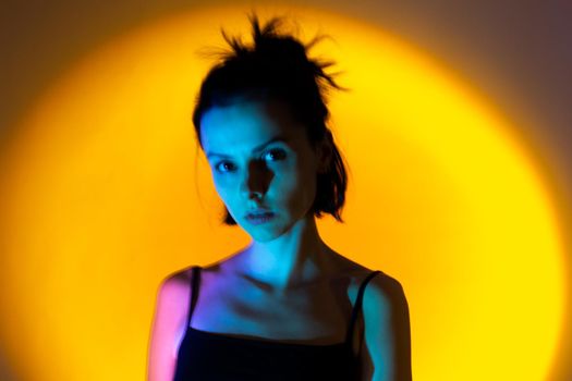 art portrait of a woman with blue light on her face, yellow background,. High quality photo