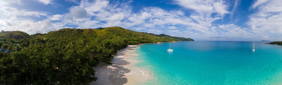 Praslin Seychelles tropical island with withe beaches and palm trees, Anse Lazio beach,Palm tree stands over deserted tropical island dream beach in Anse Lazio, Seychelles.