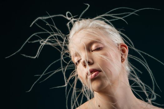 Portrait of a girl with lively curly hair. A young gorgon jellyfish from mythology. Art object