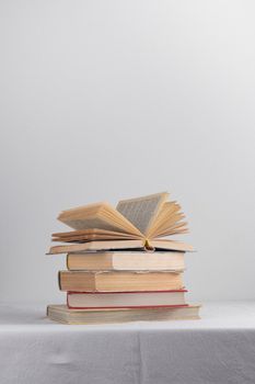 Stack of old rustic vintage books on white table