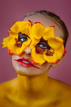 Girl model with yellow flowers around her eyes. Flower Girl