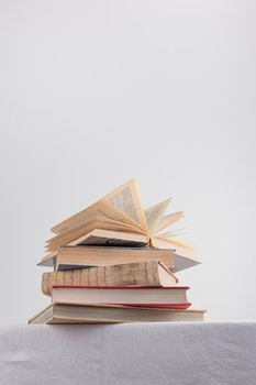 Stack of old rustic vintage books on white table