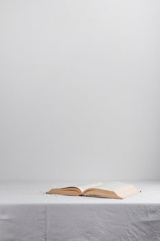 Stack of old rustic vintage books on white table