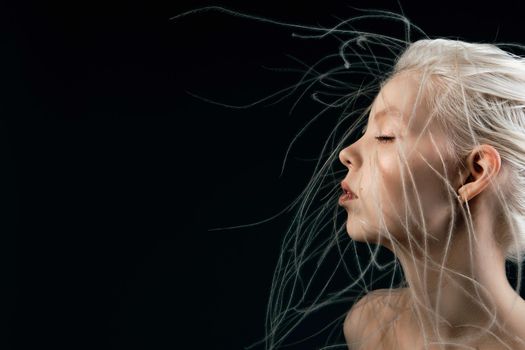 Portrait of a girl with lively curly hair. A young gorgon jellyfish from mythology. Art object