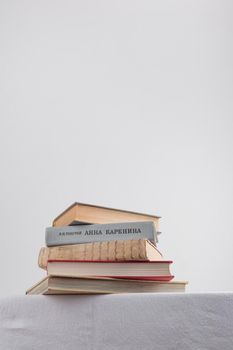 Stack of old rustic vintage books on white table